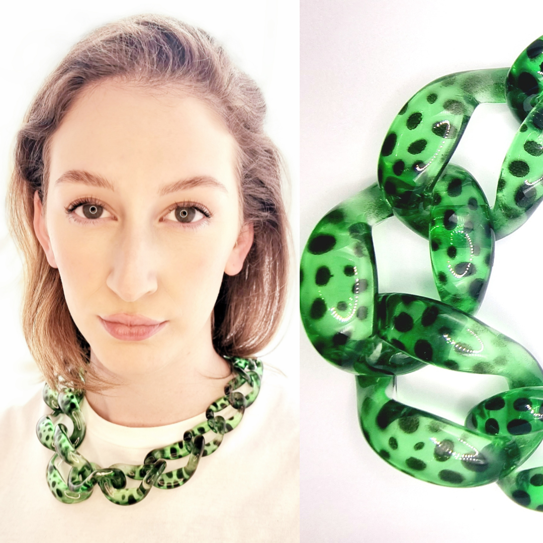 Portrait of a woman wearing a green leopard print chain necklace