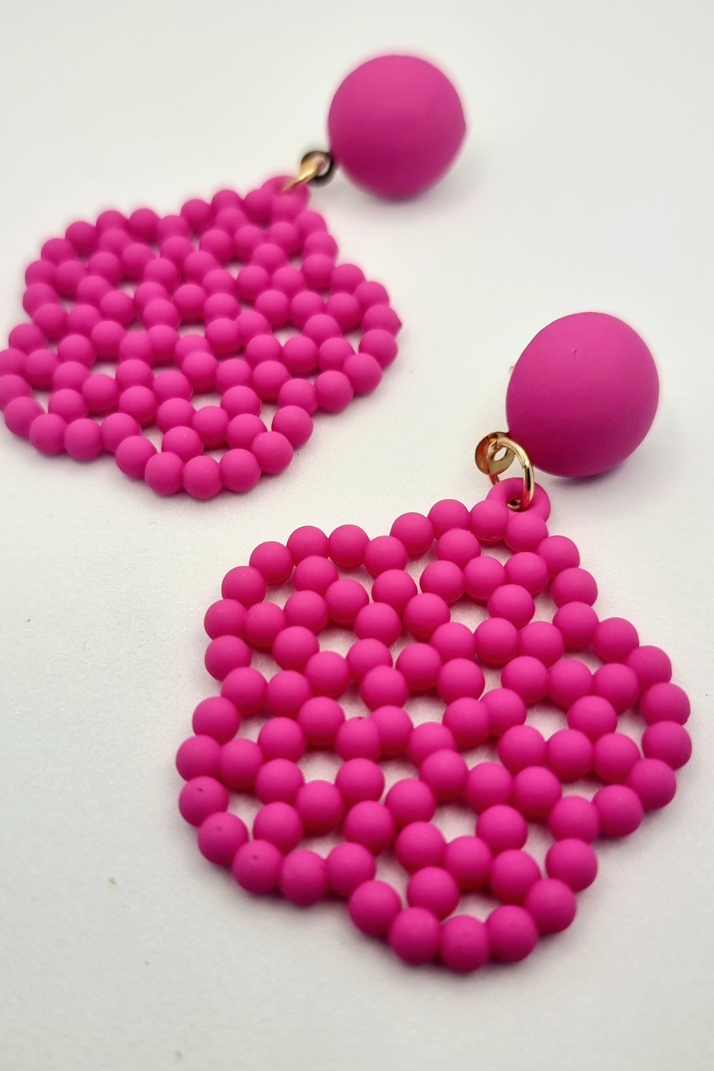 Pink beaded flower drop earring.