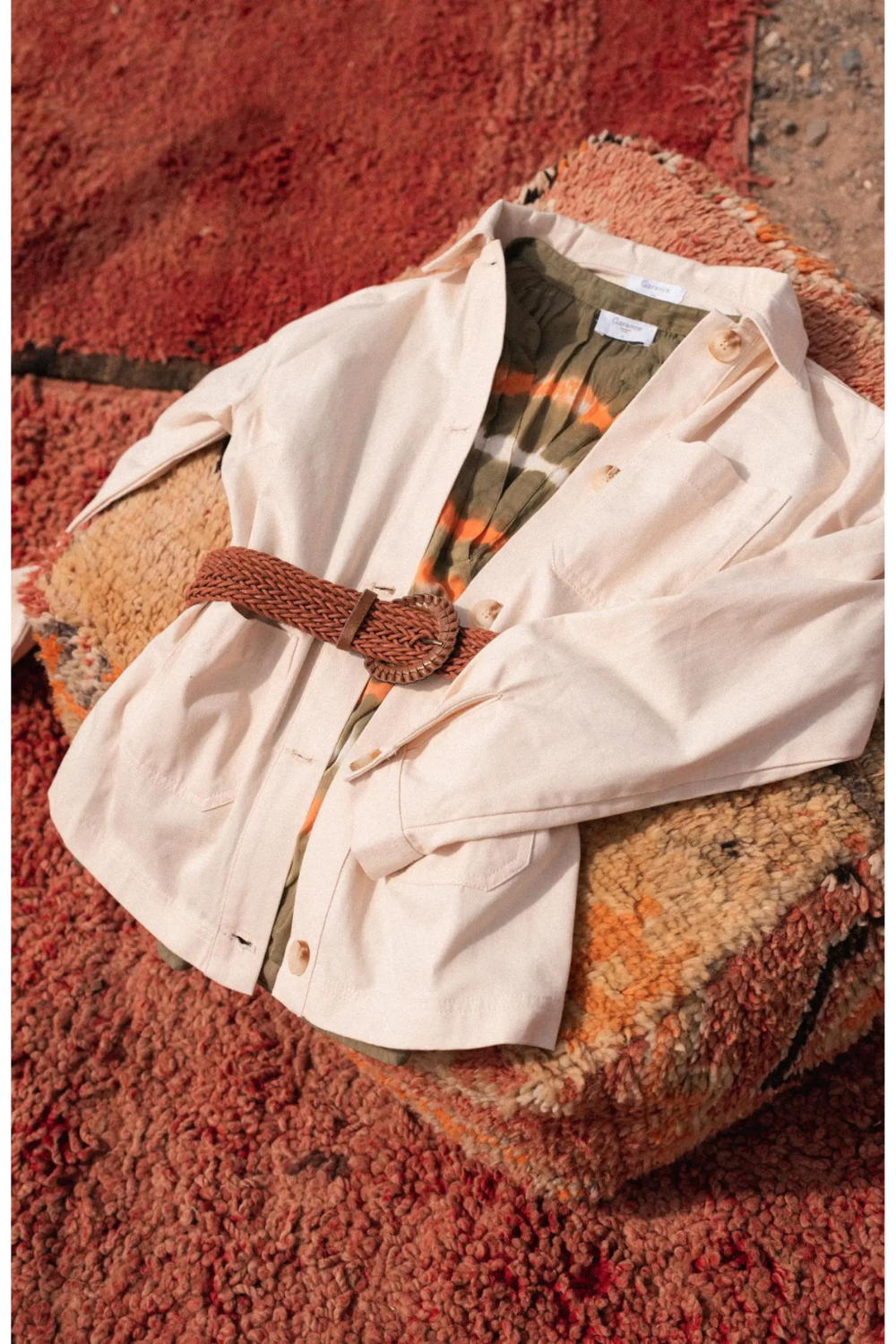 Ecru jacket with belt or a rustic coloured rug