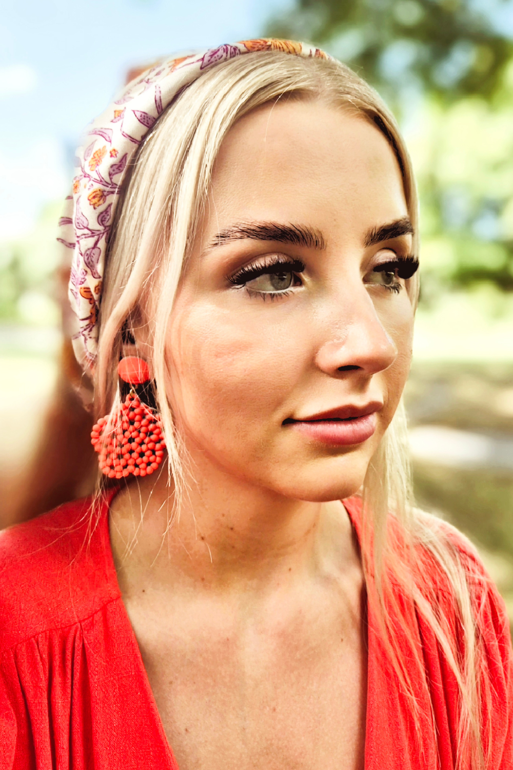 woman wearing a n orange flower head scarf 