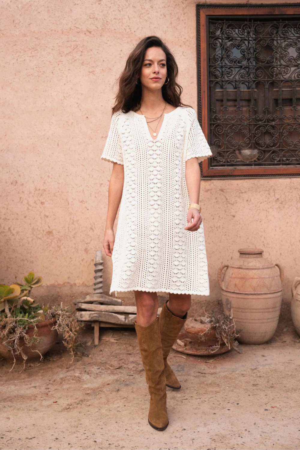 Model wearing cream knit, knee length dress