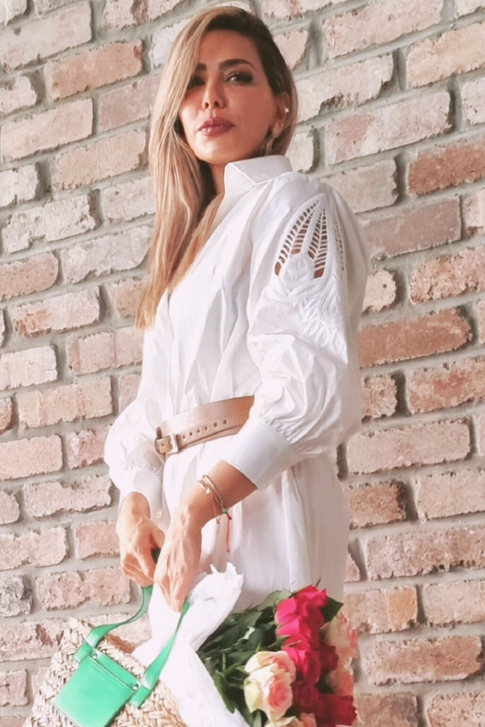 Model wearing a white shirt dress with lace/embroidery detail sleeve