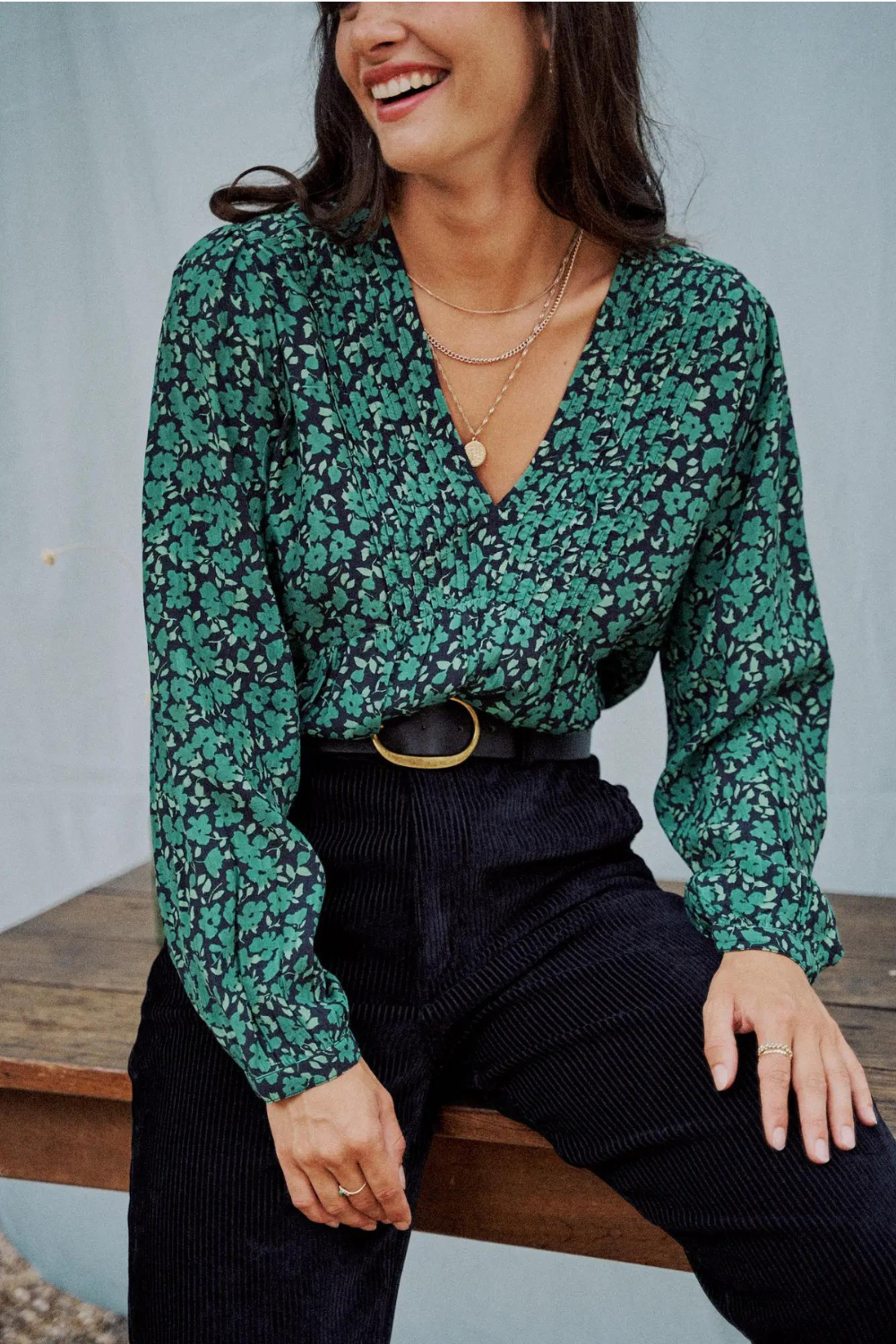 Woman wearing a green flower print blouse