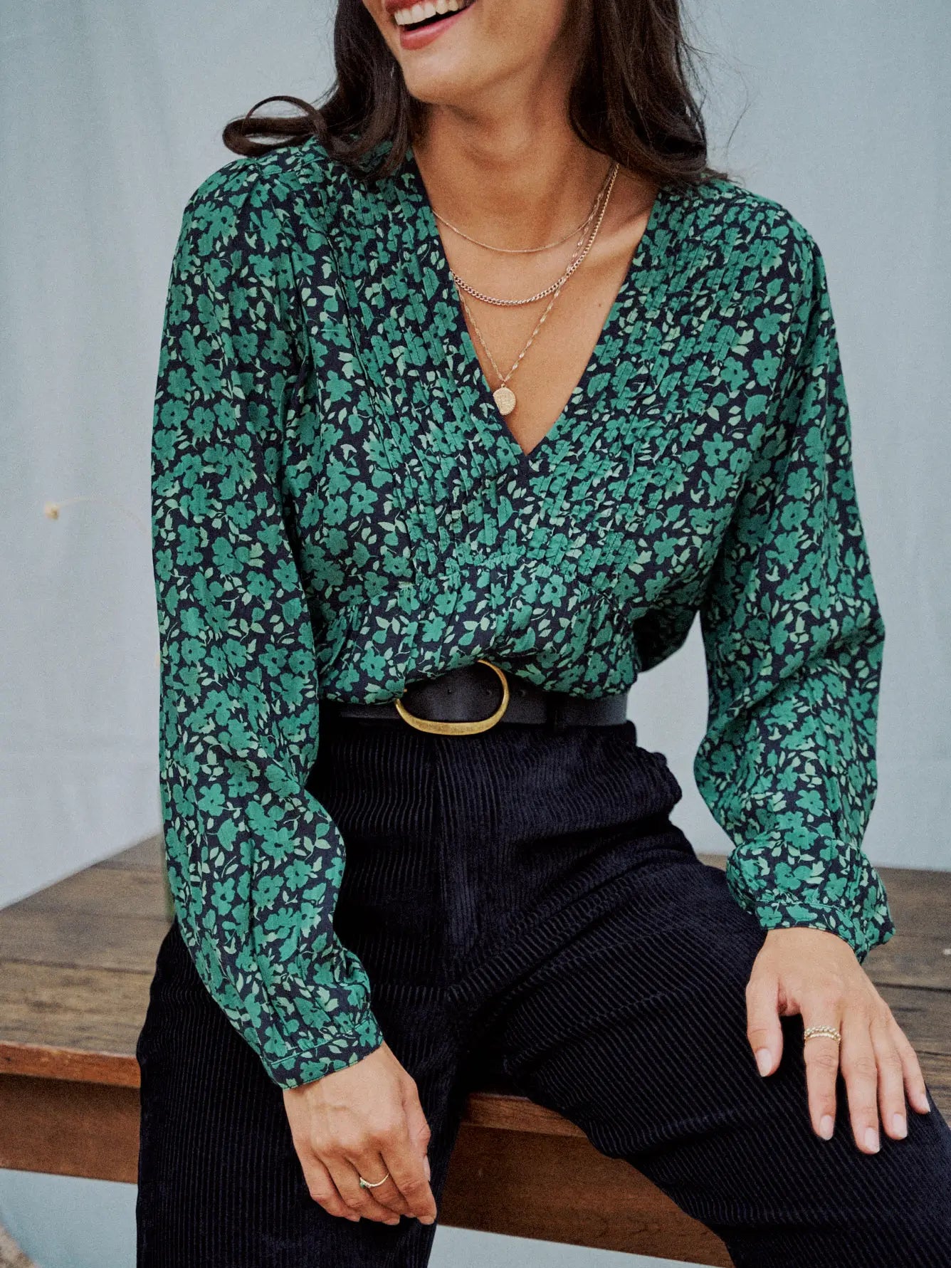 Woman wearing a green flower print blouse